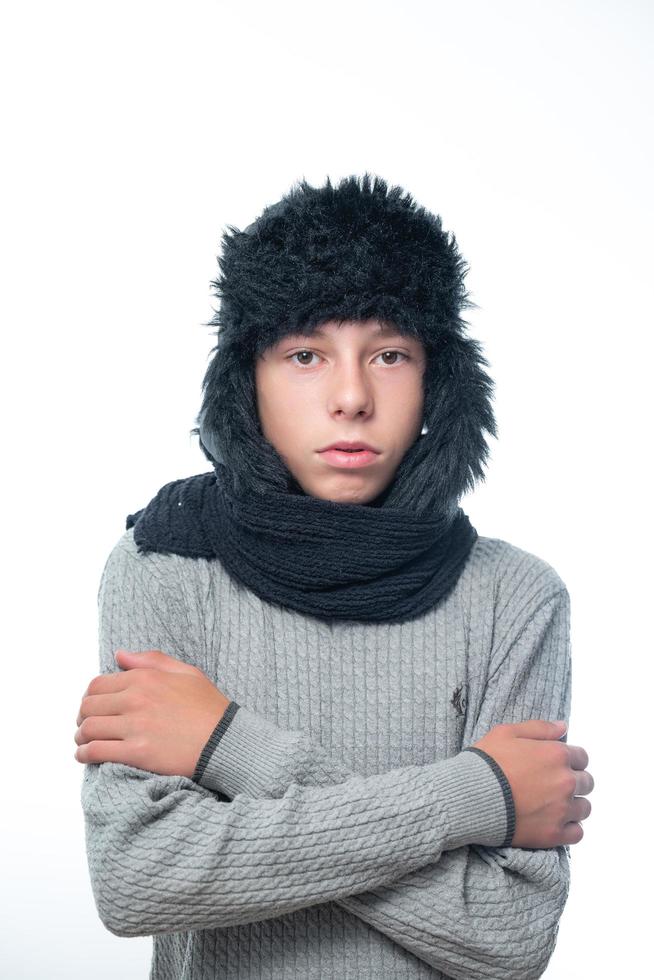 Portrait of upset guy in winter hat and scarf, cold winter and crisis time. photo
