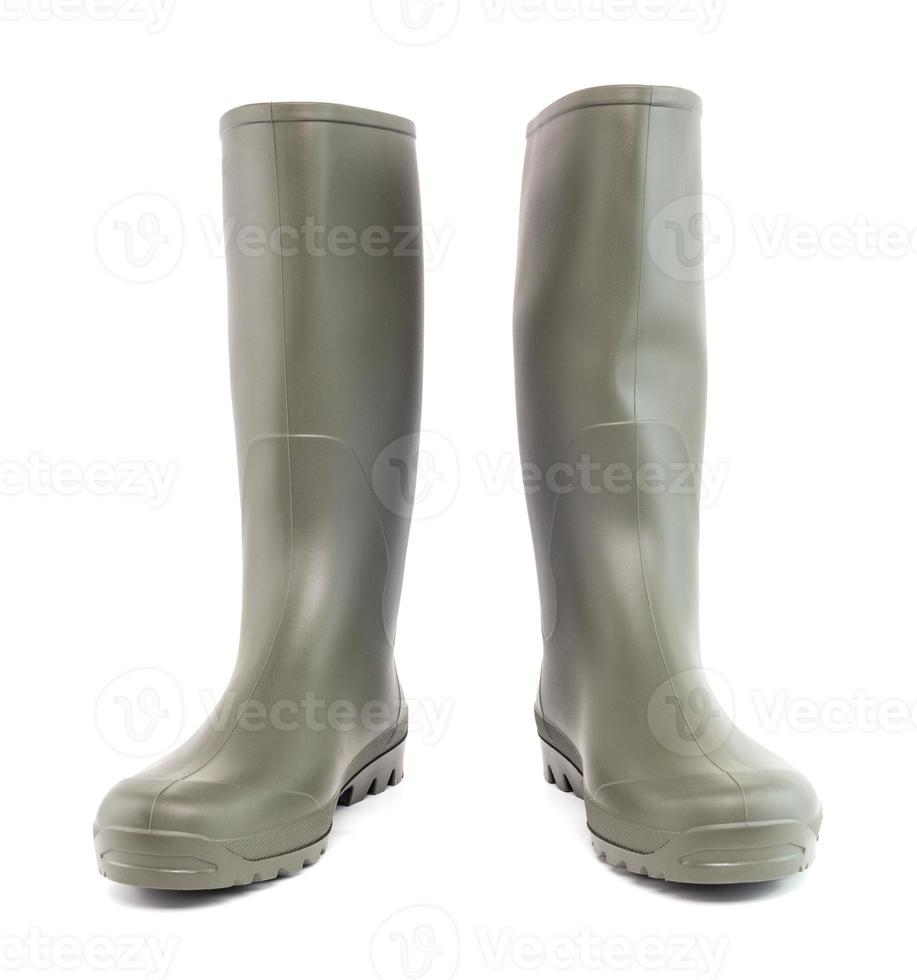 A pair of clean green rubber boots standing up, isolated on white background. Front view. photo