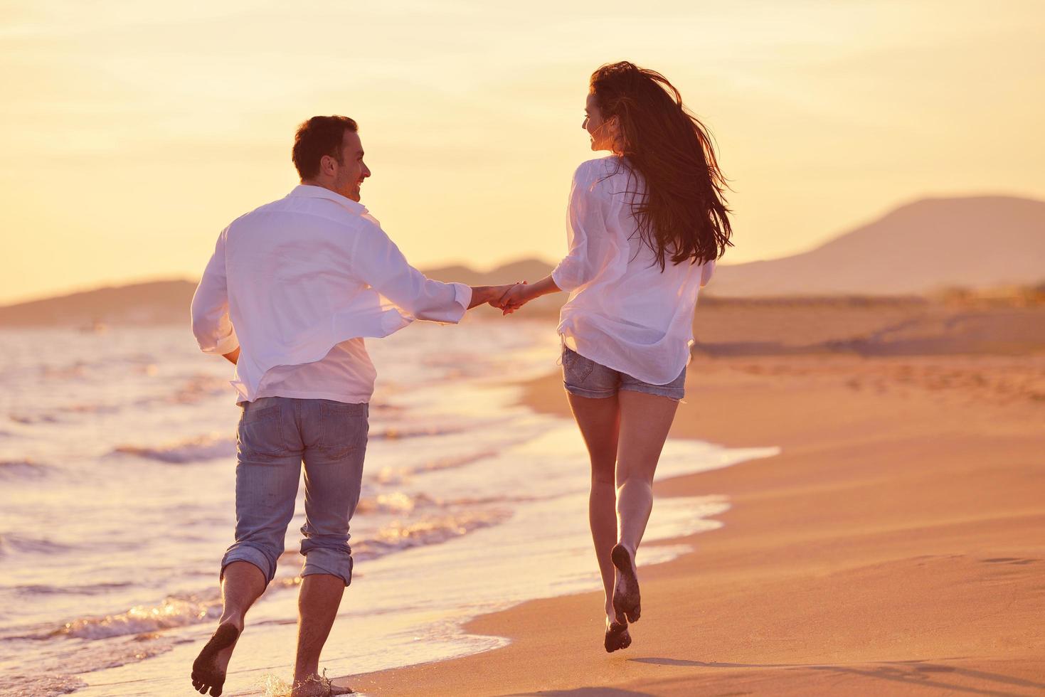 young couple  on beach have fun photo