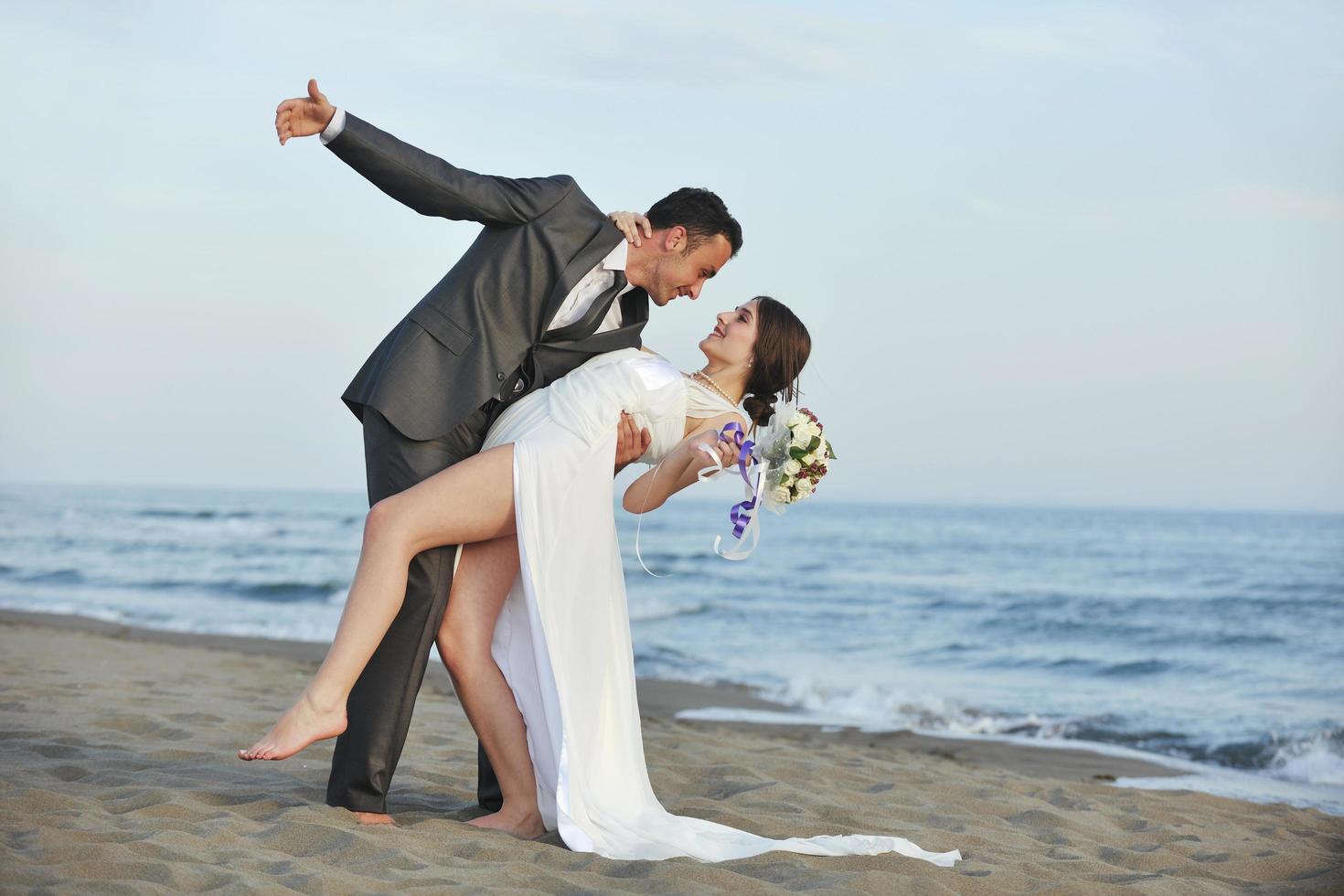 romantic beach wedding at sunset photo