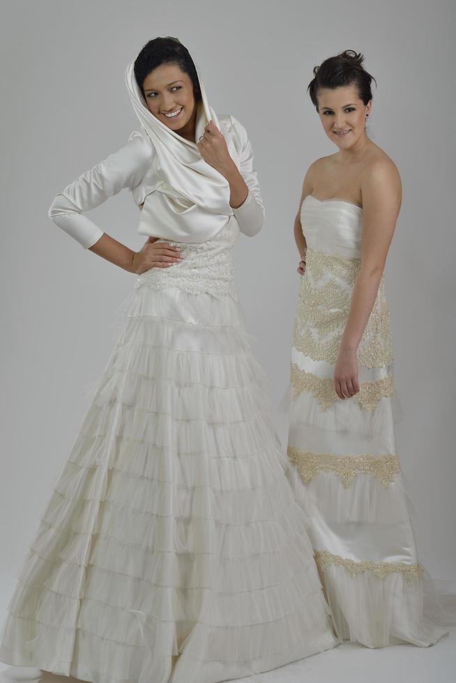 portrait of a three beautiful woman in wedding dress photo