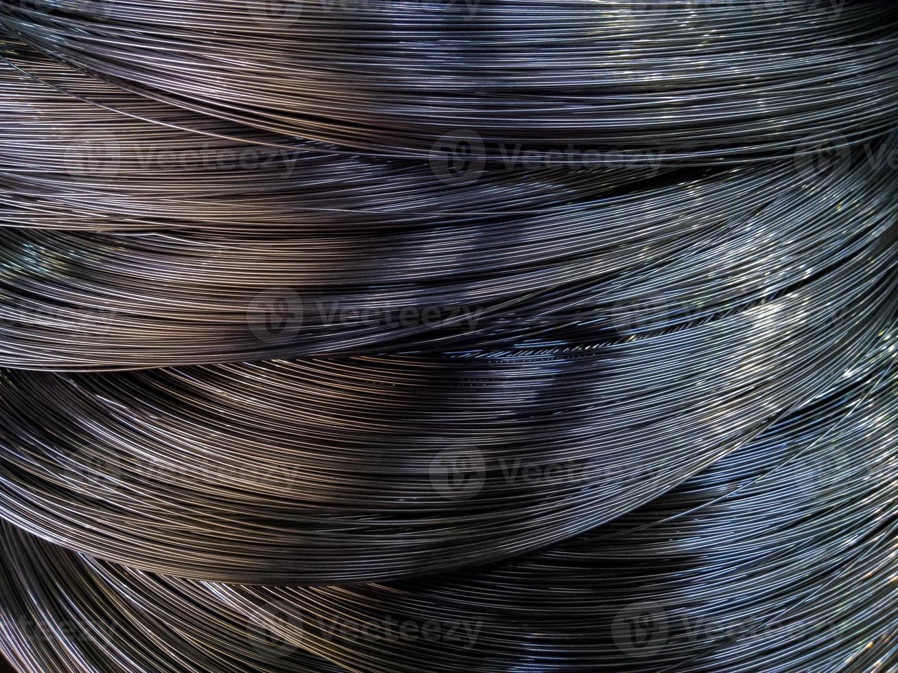 Closeup background of metal wire roll in silver color. Building material. Texture with selective focus. photo