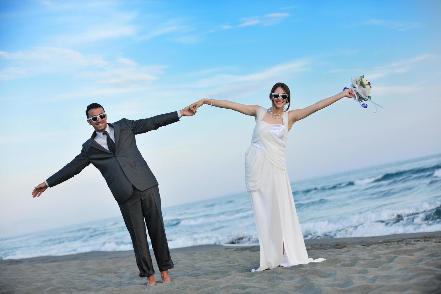romantic beach wedding at sunset photo
