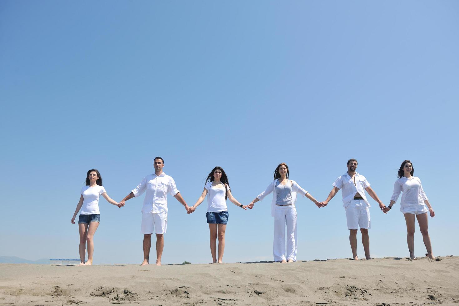 happy people group have fun and running on beach photo