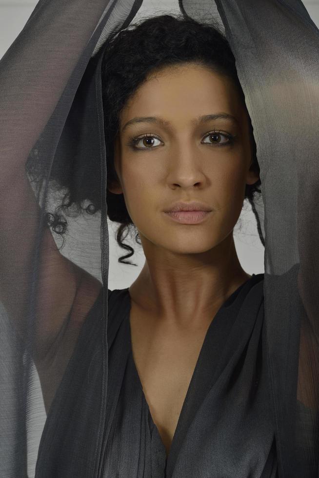 elegant woman in fashionable dress posing in the studio photo