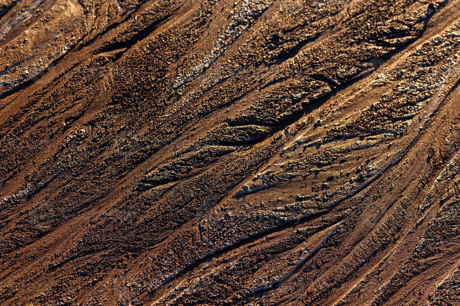 abstract mud background with water washout trails and selective focus photo