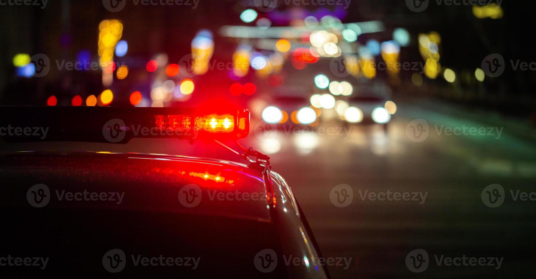 police car lights in night city with selective focus and bokeh photo