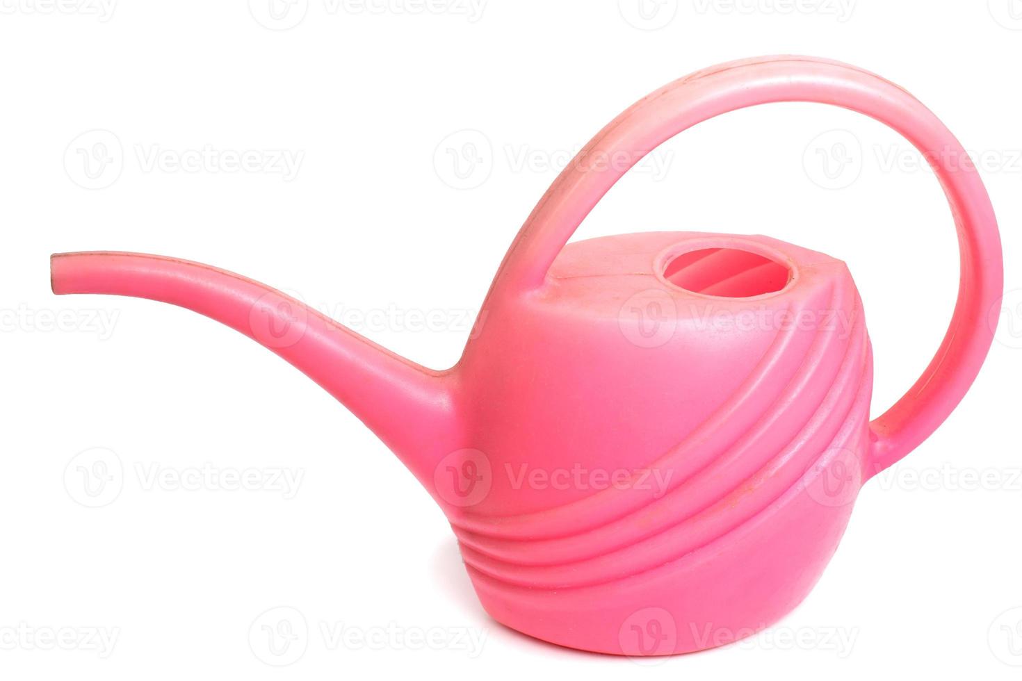 Old dirty pink plastic watering can isolated photo