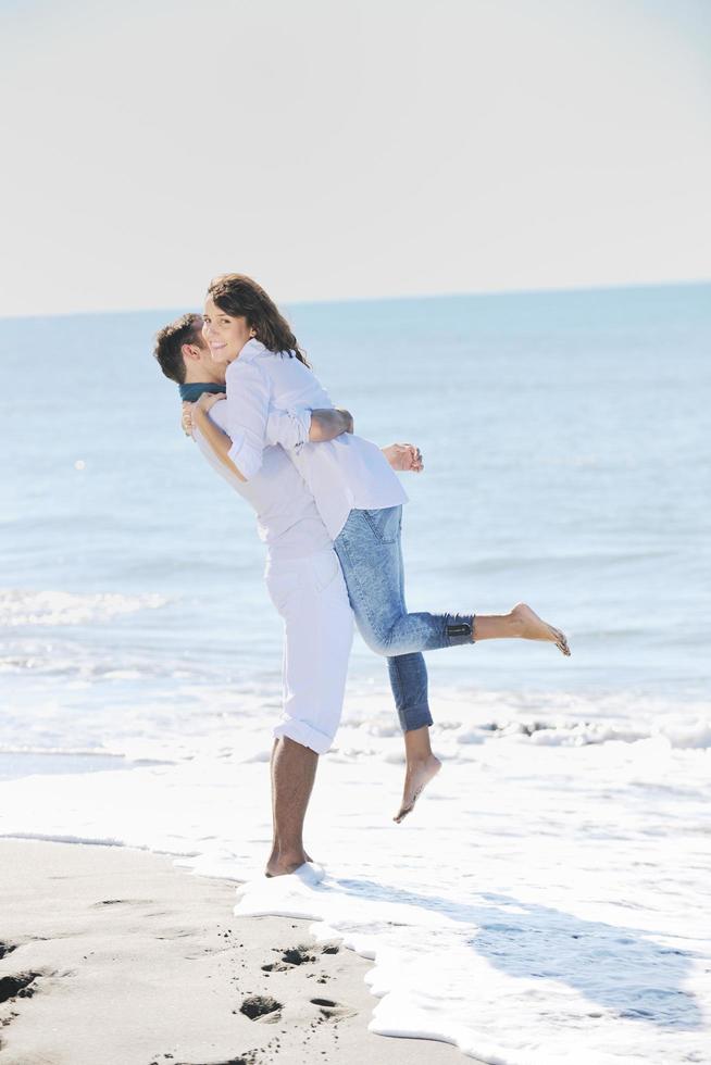 happy young couple have fun at beautiful beach photo