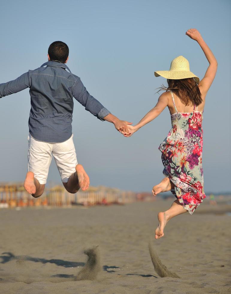 couple on beach with travel bag photo