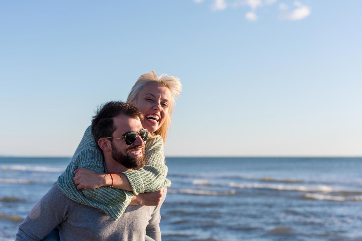 couple having fun at beach during autumn photo