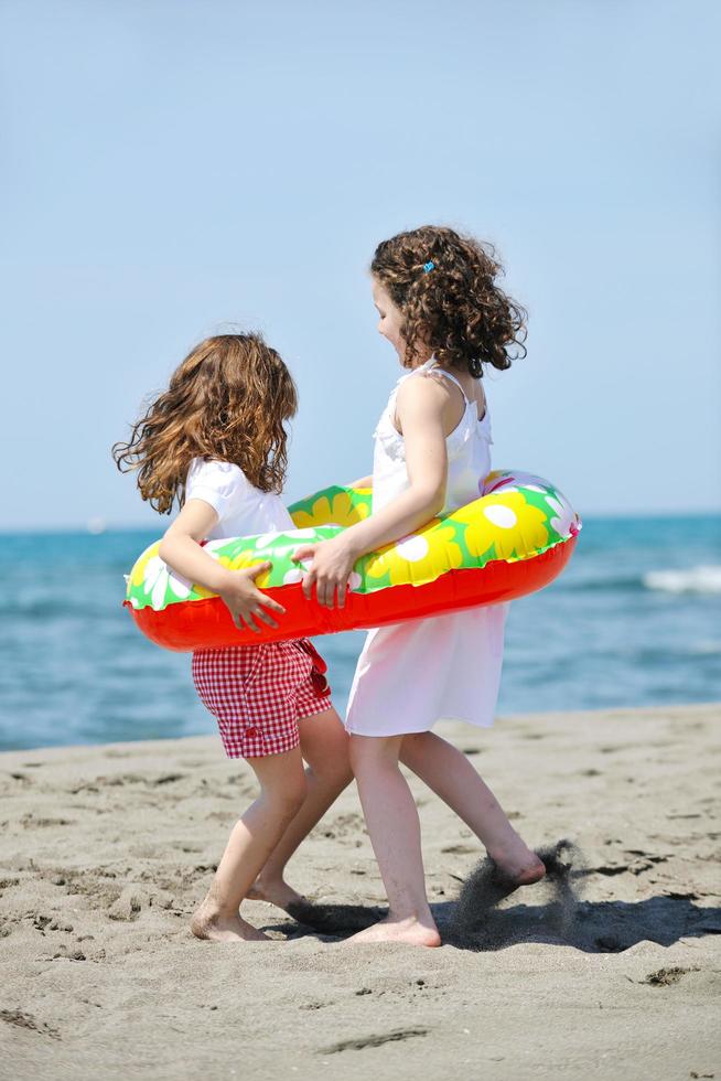 happy child group playing  on beach photo