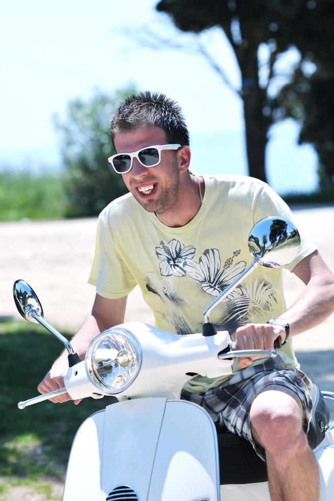 young man ride retro scooter photo