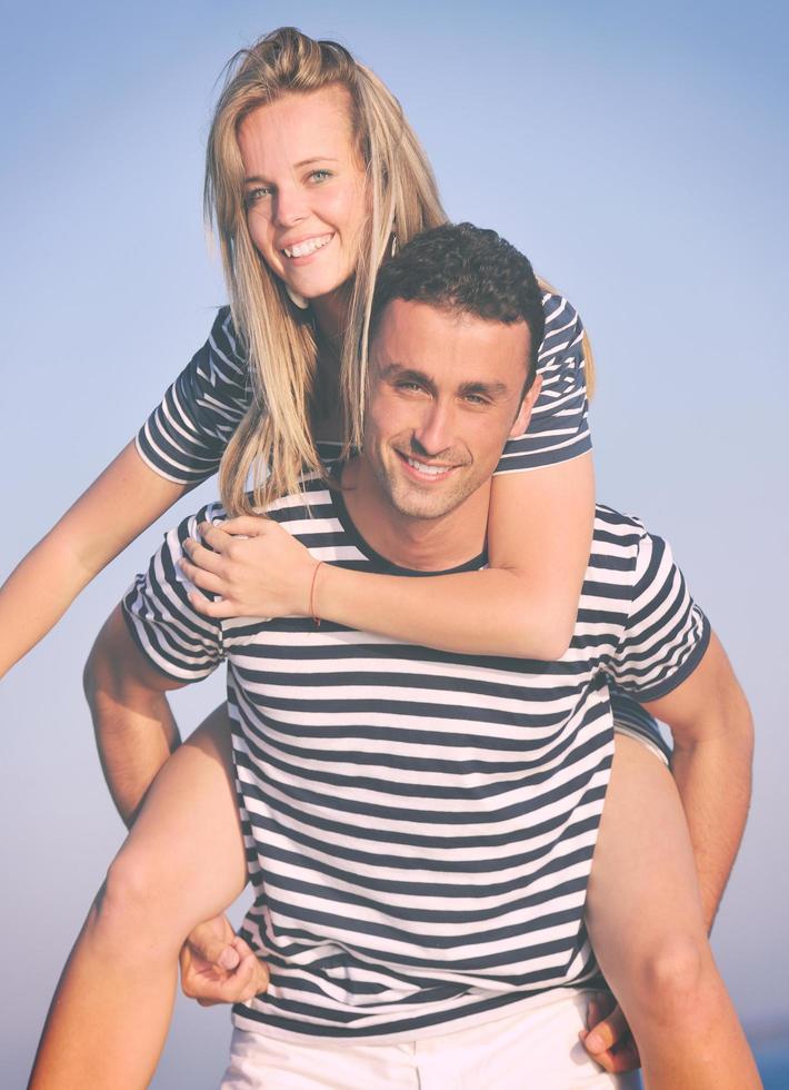 happy young couple have romantic time on beach photo