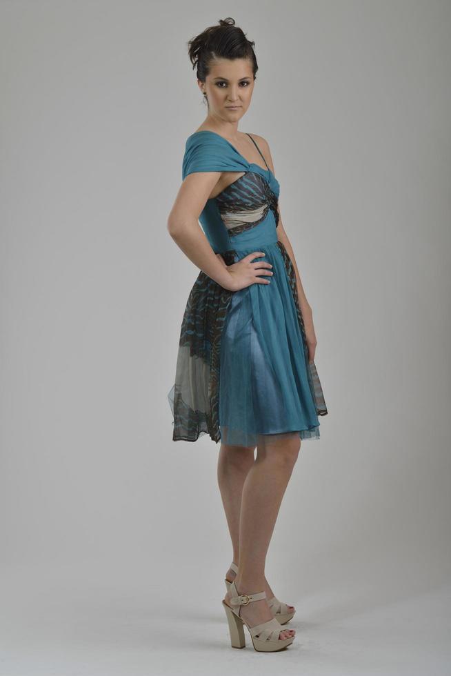 elegant woman in fashionable dress posing in the studio photo