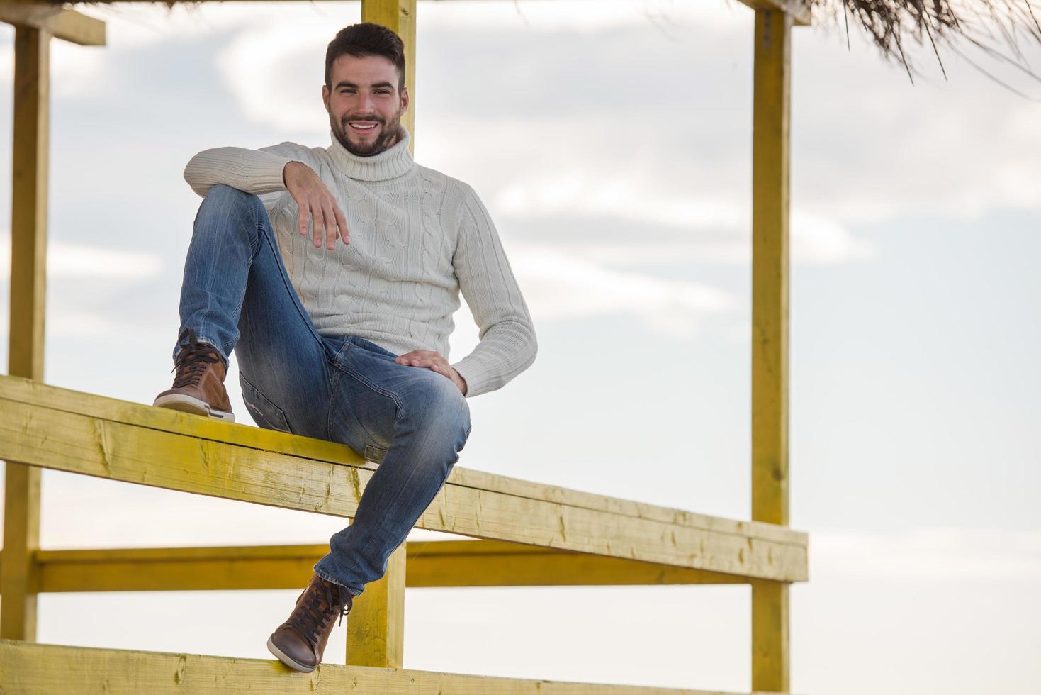 Young man enjoying the warm autumn day photo