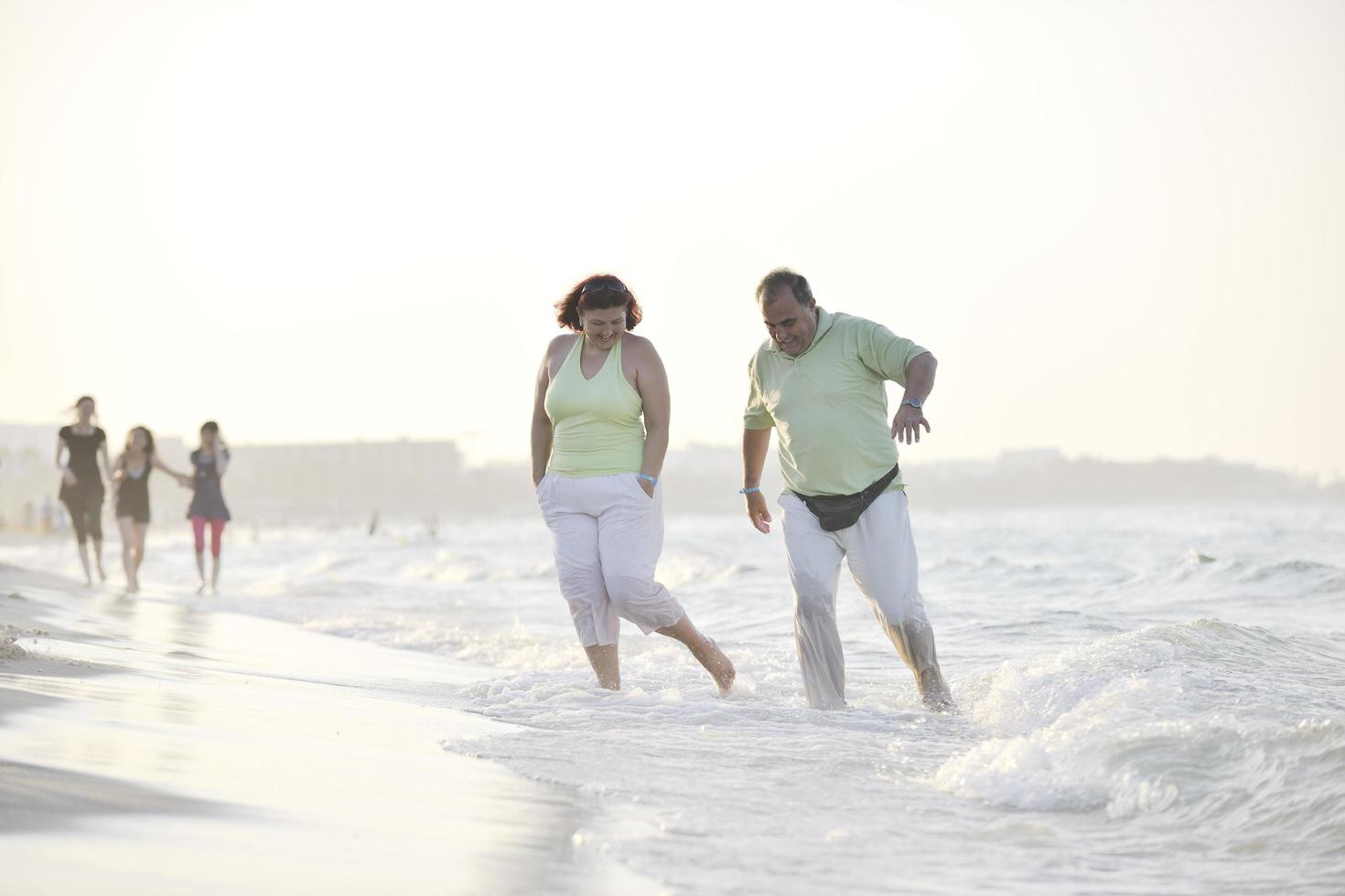 happy seniors couple  on beach photo