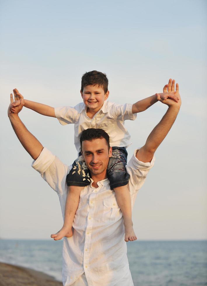 happy young family have fun on beach photo
