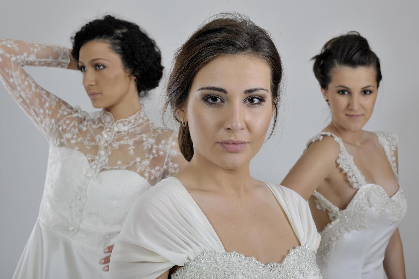 portrait of a three beautiful woman in wedding dress photo