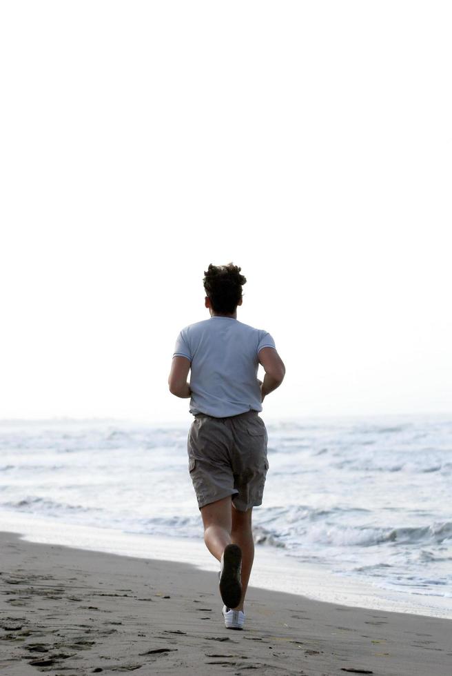 man running on beach photo