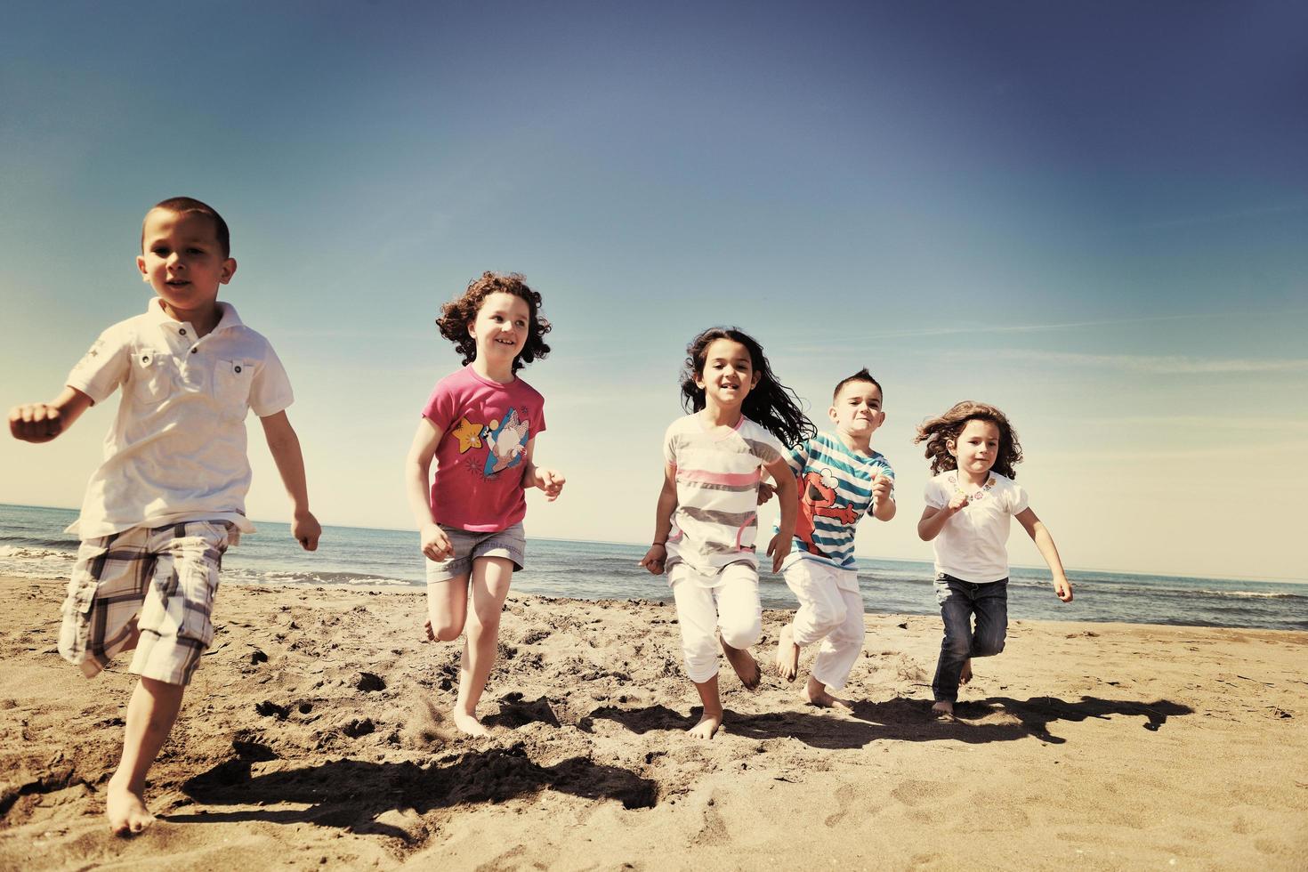 happy young  people group have fun on beach photo