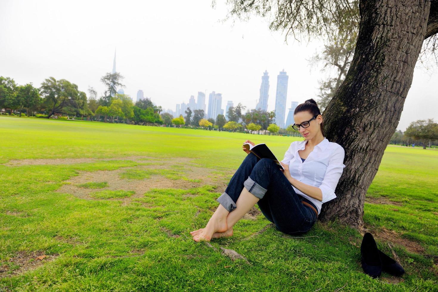 Young woman reading a book in the park photo