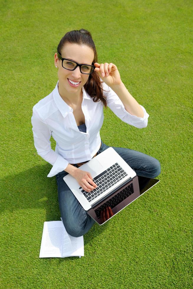 woman with laptop in park photo