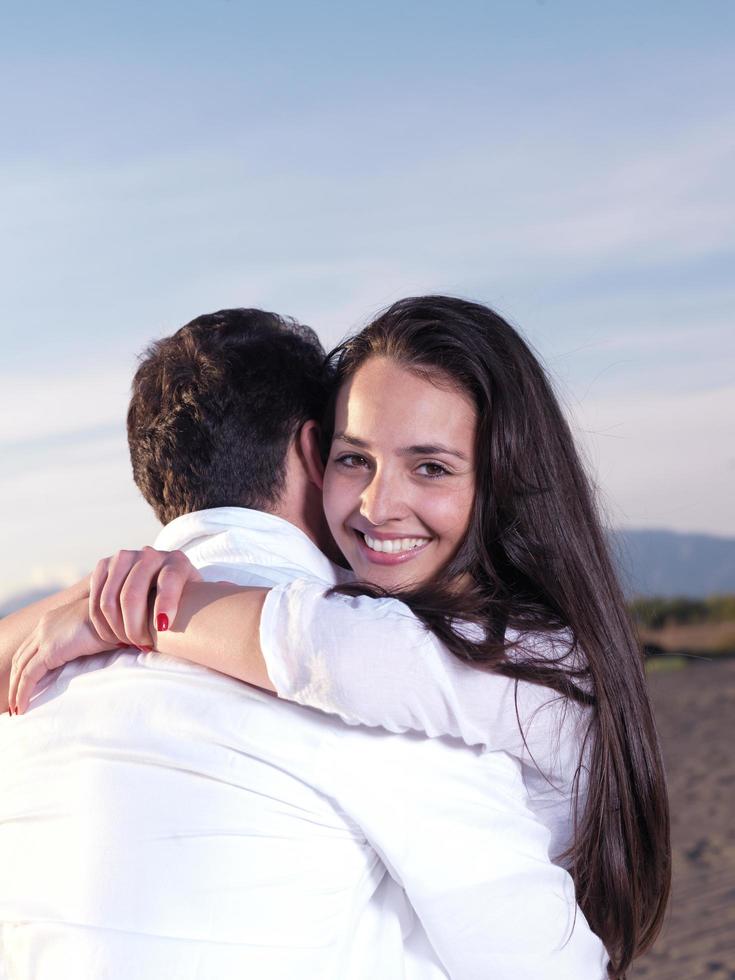 young couple  on beach have fun photo