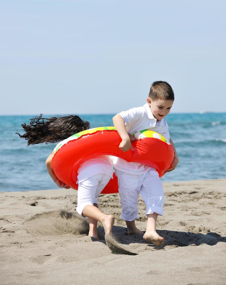 happy child group playing  on beach photo