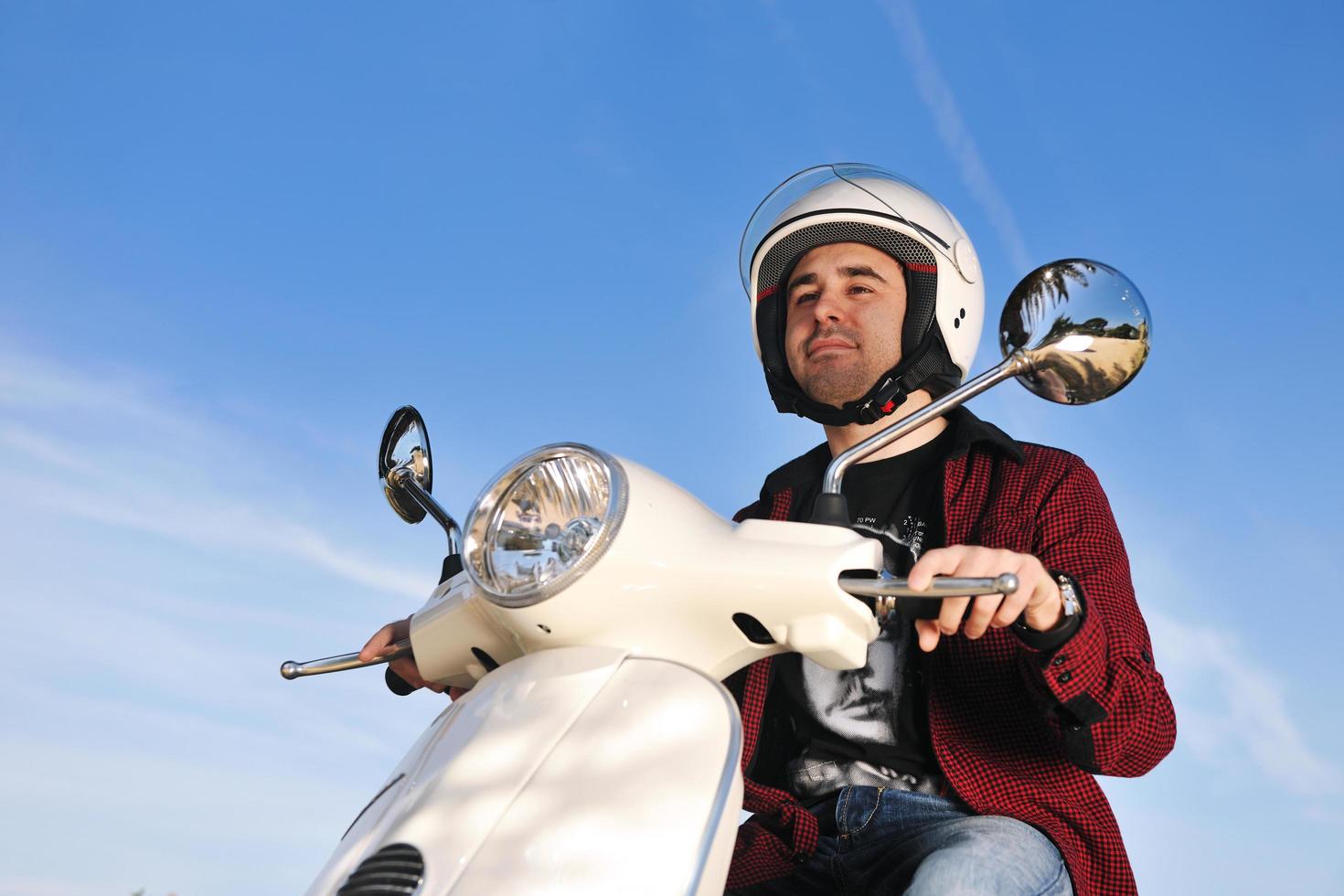 young man on ride scooter photo