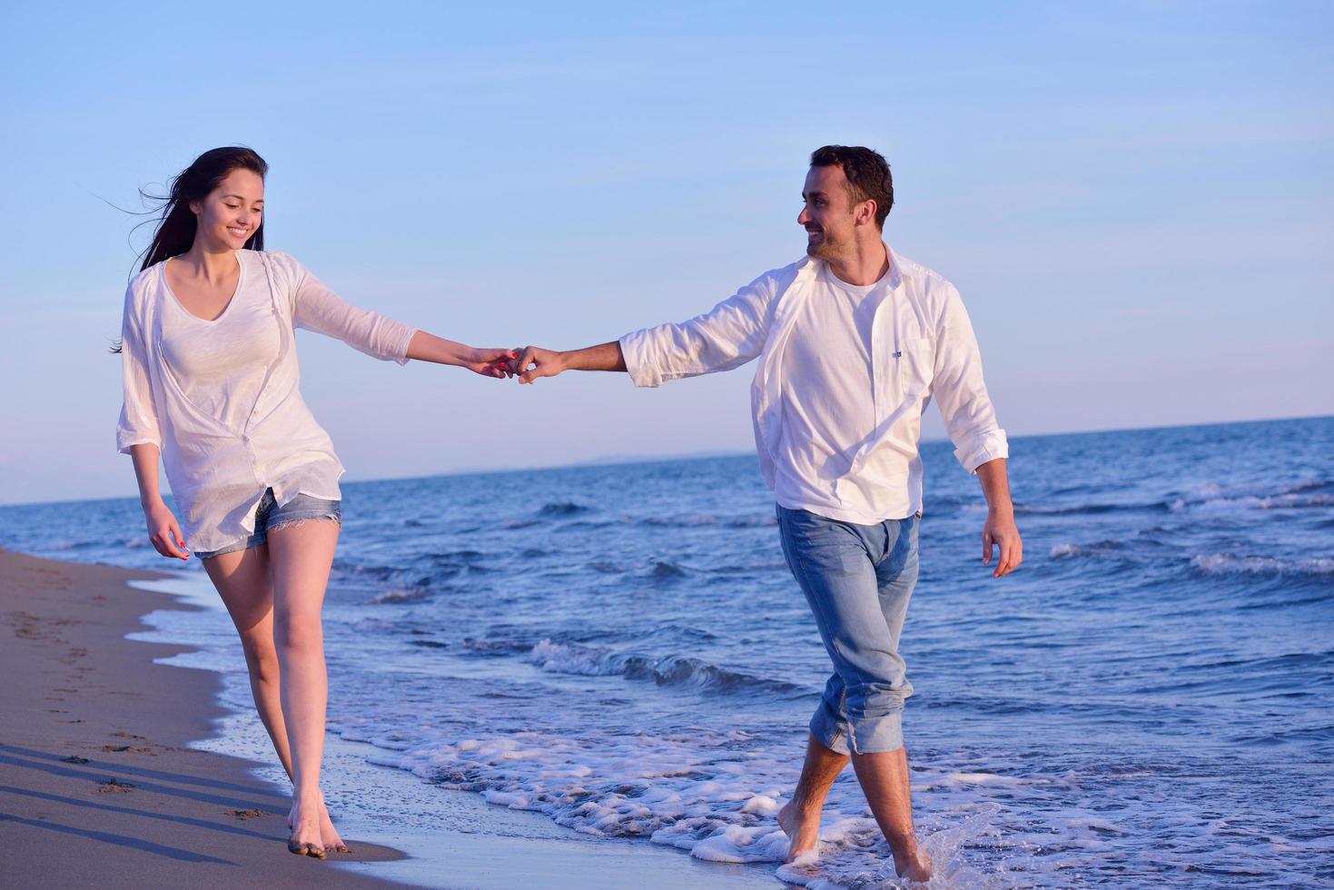 young couple  on beach have fun photo