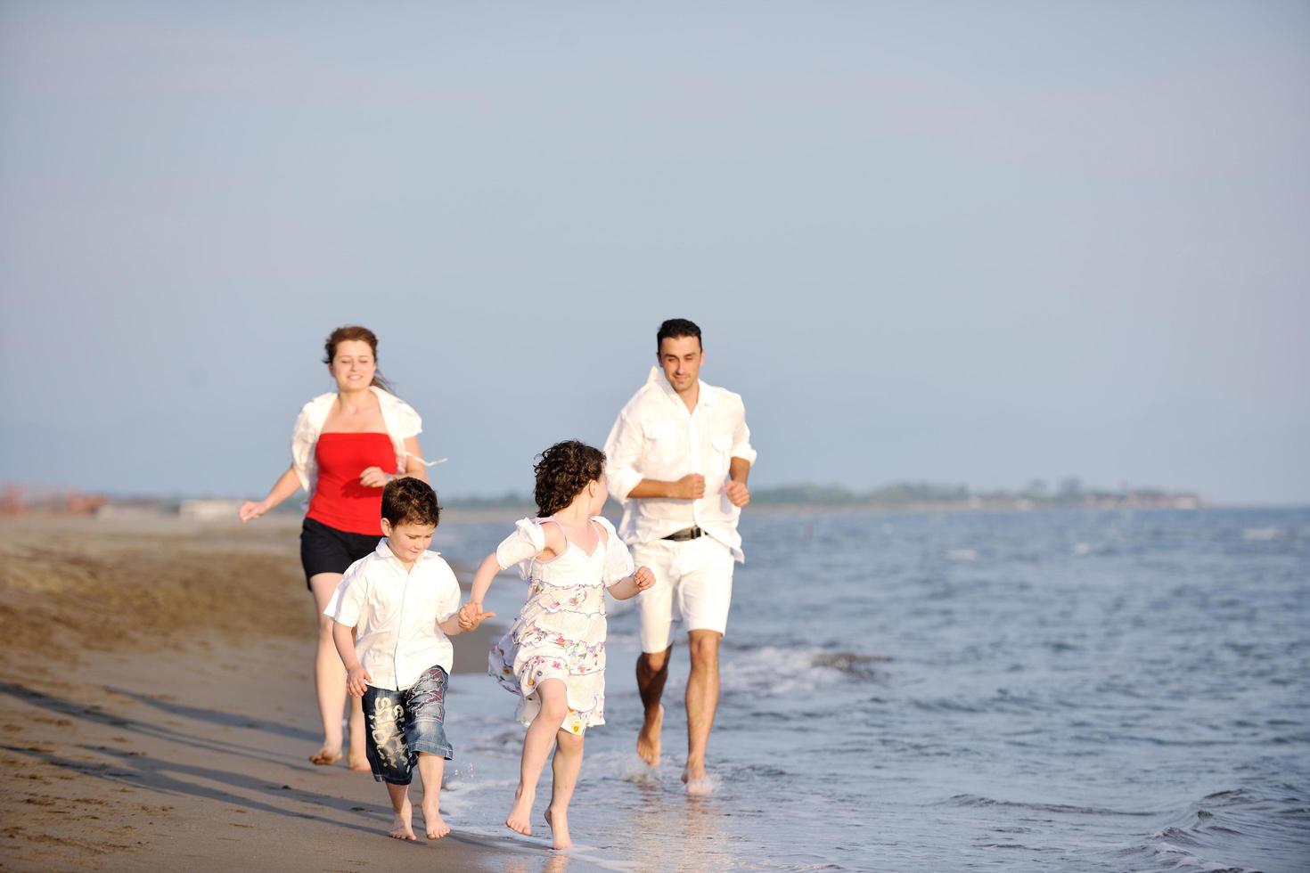 happy young family have fun on beach photo