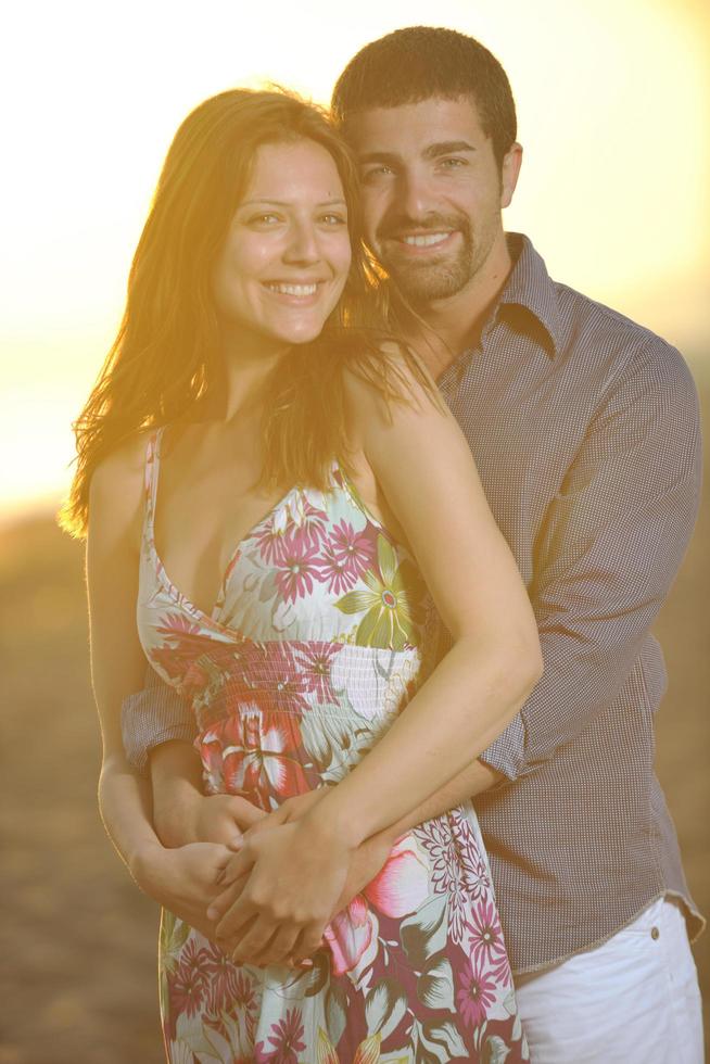 happy young couple have romantic time on beach photo