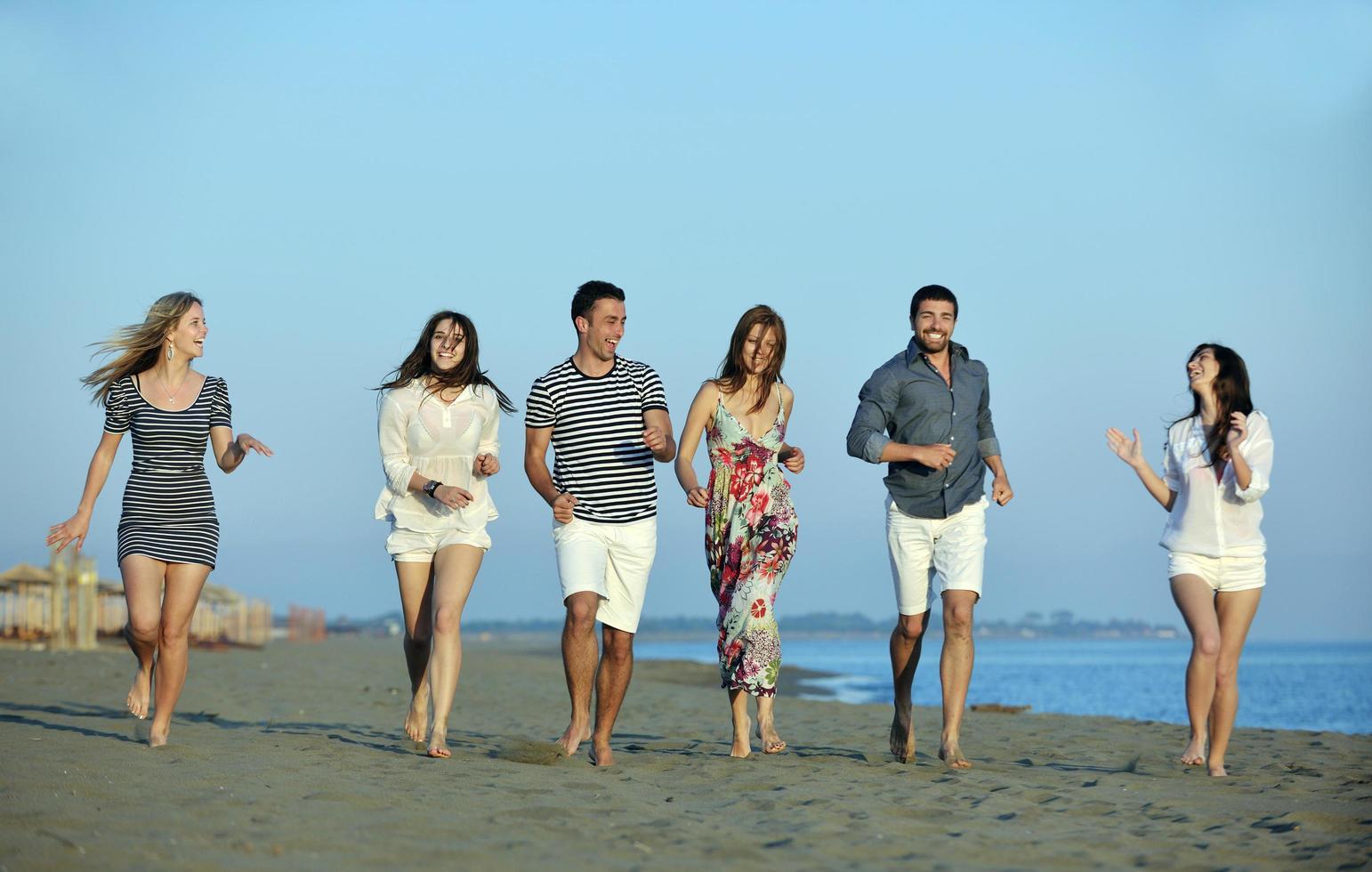 happy young  people group have fun on beach photo