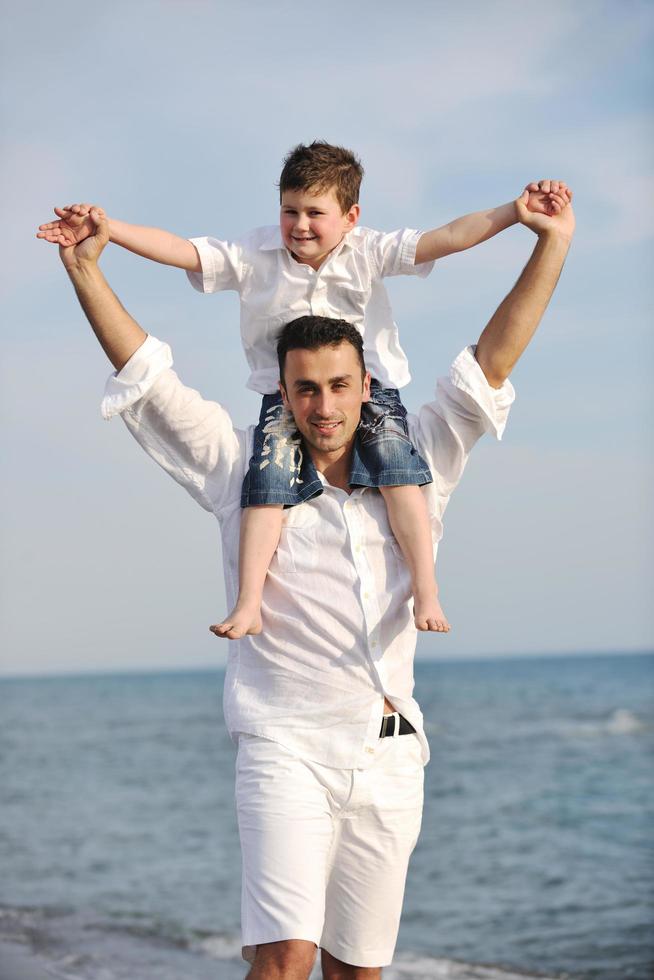 happy father and son have fun and enjoy time on beach photo