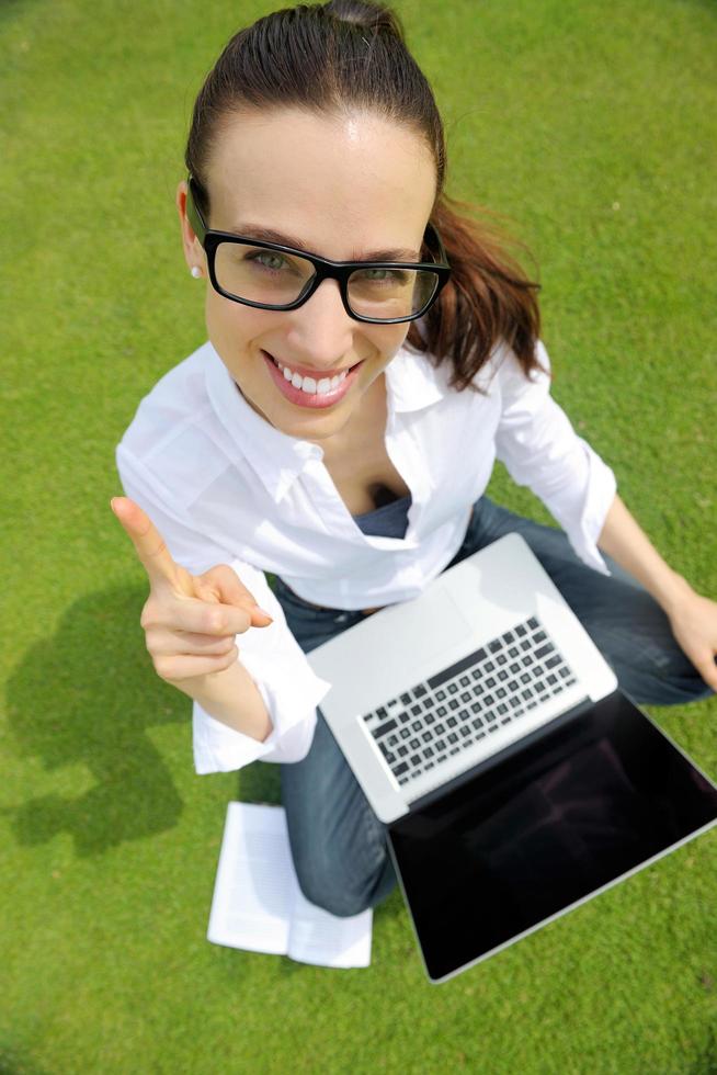 woman with laptop in park photo