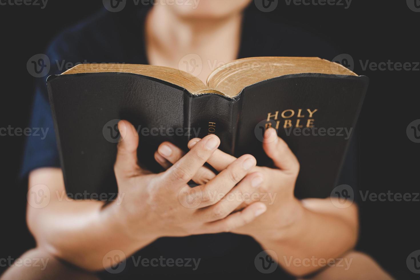 Young woman person hand holding holy bible with study at home. Adult female christian reading book in church. Girl learning religion spirituality with pray to god. concept of student education faith. photo