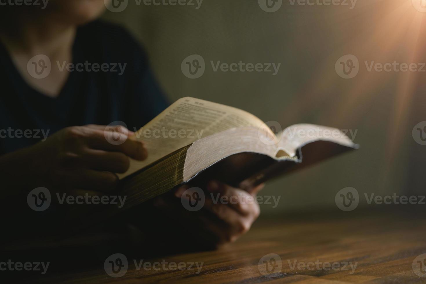 Prayer person hand in black background. Christian catholic woman are praying to god in dark at church. Girl believe and faith in jesus christ. Christ religion and christianity worship or pray concept. photo