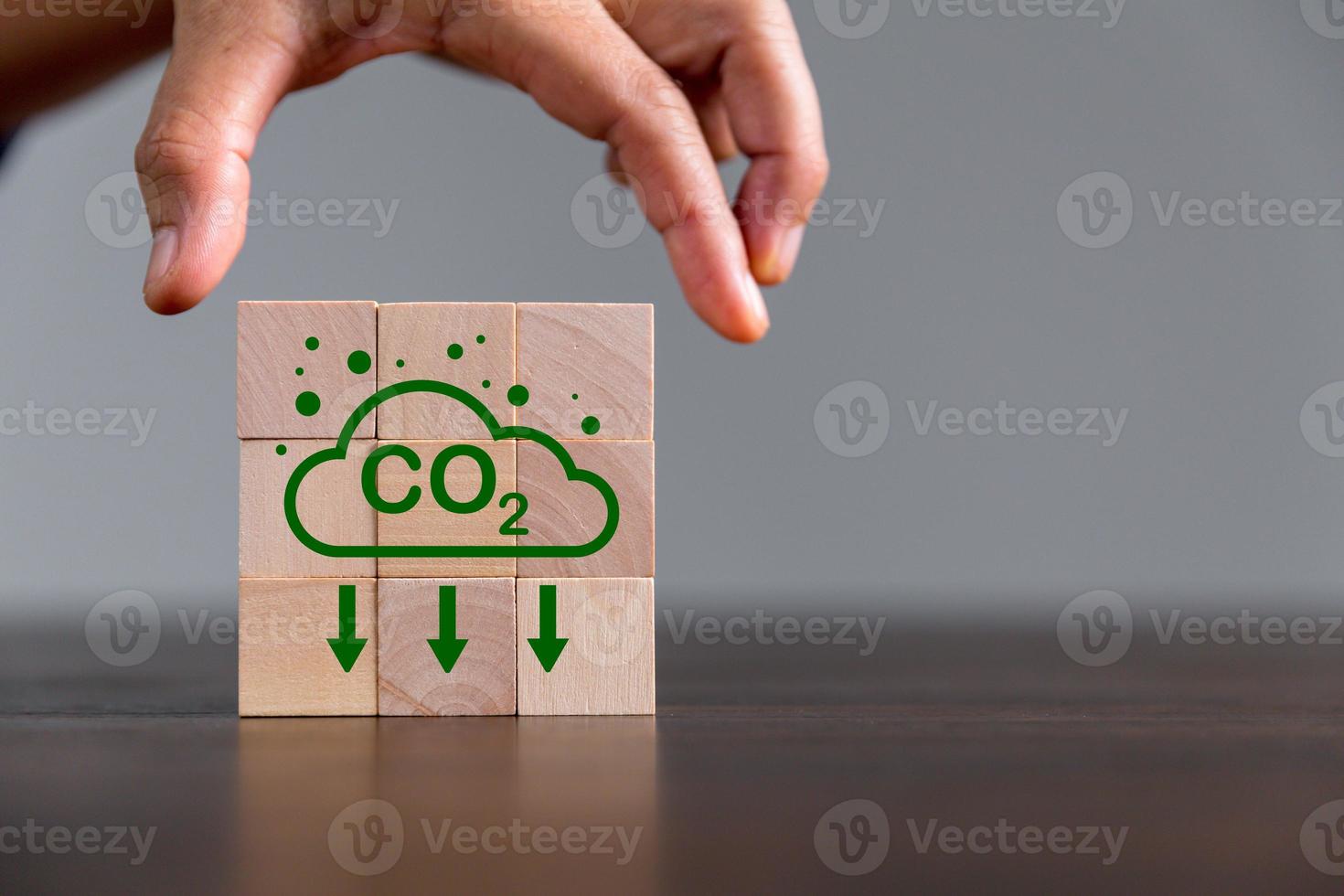 Companies are targeting net zero greenhouse gas emissions. Carbon credit concept.Tradable certificate to drive industry in direction of low emissions in efficiency cost. Wooden cubes with decrease CO2 photo