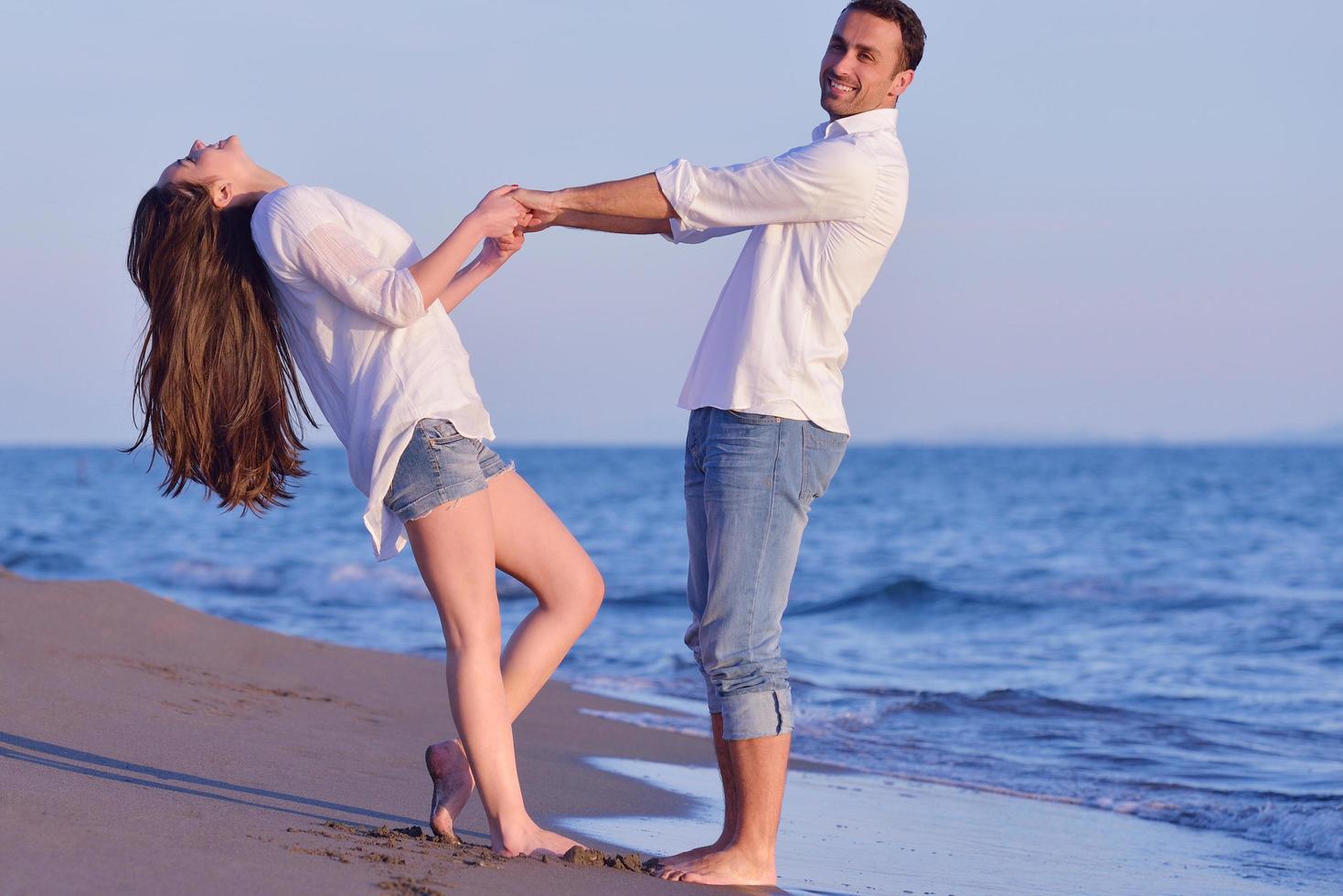 young couple  on beach have fun photo