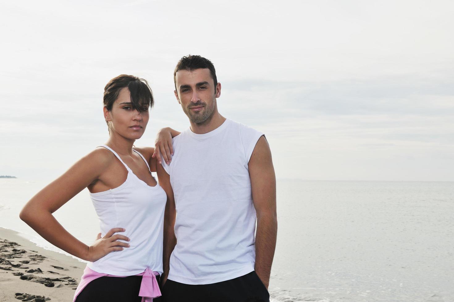 happy young couple have fun at beautiful beach photo