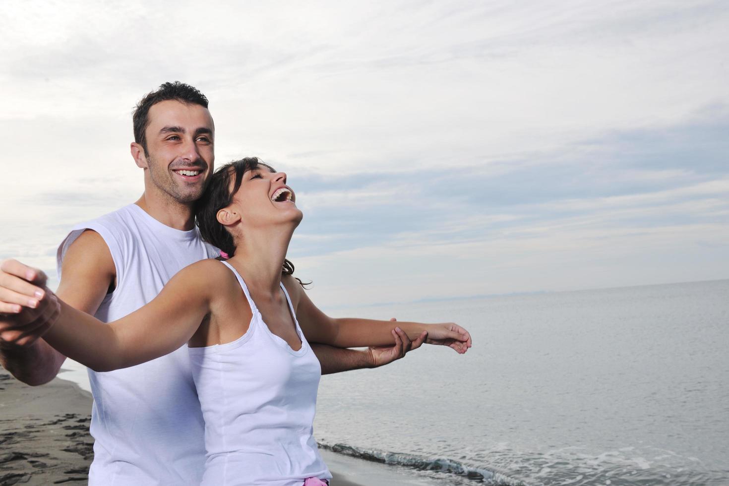 happy young couple have fun at beautiful beach photo