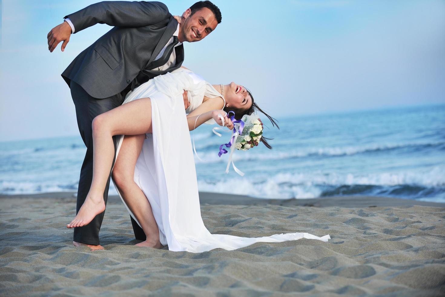 romantic beach wedding at sunset photo