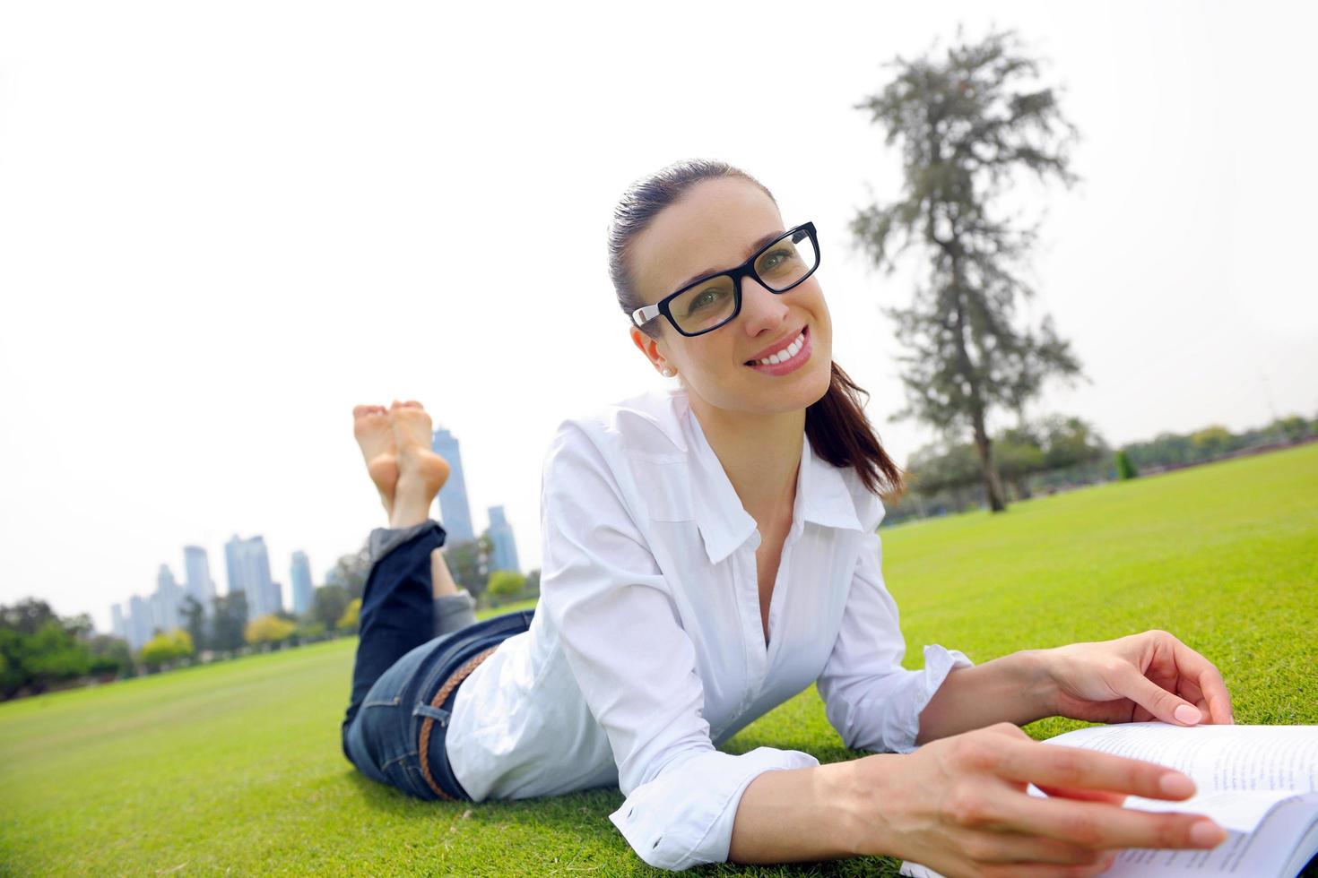 Young woman reading a book in the park photo
