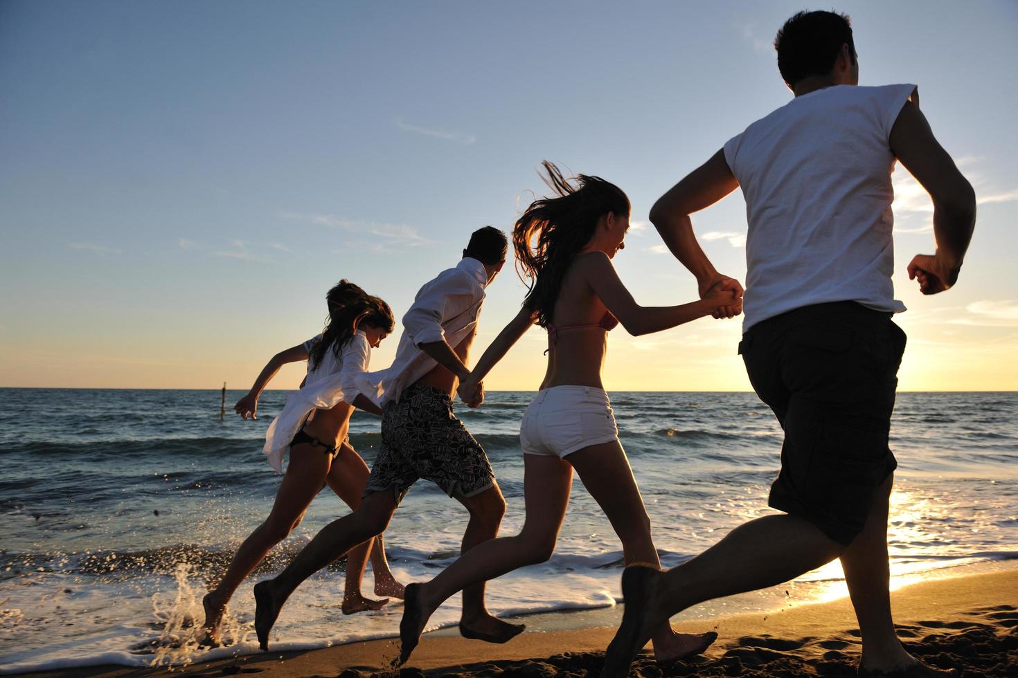 people group running on the beach photo