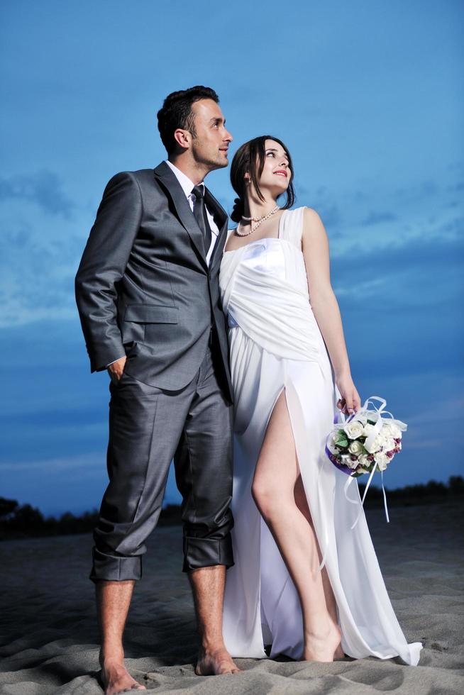 romantic beach wedding at sunset photo