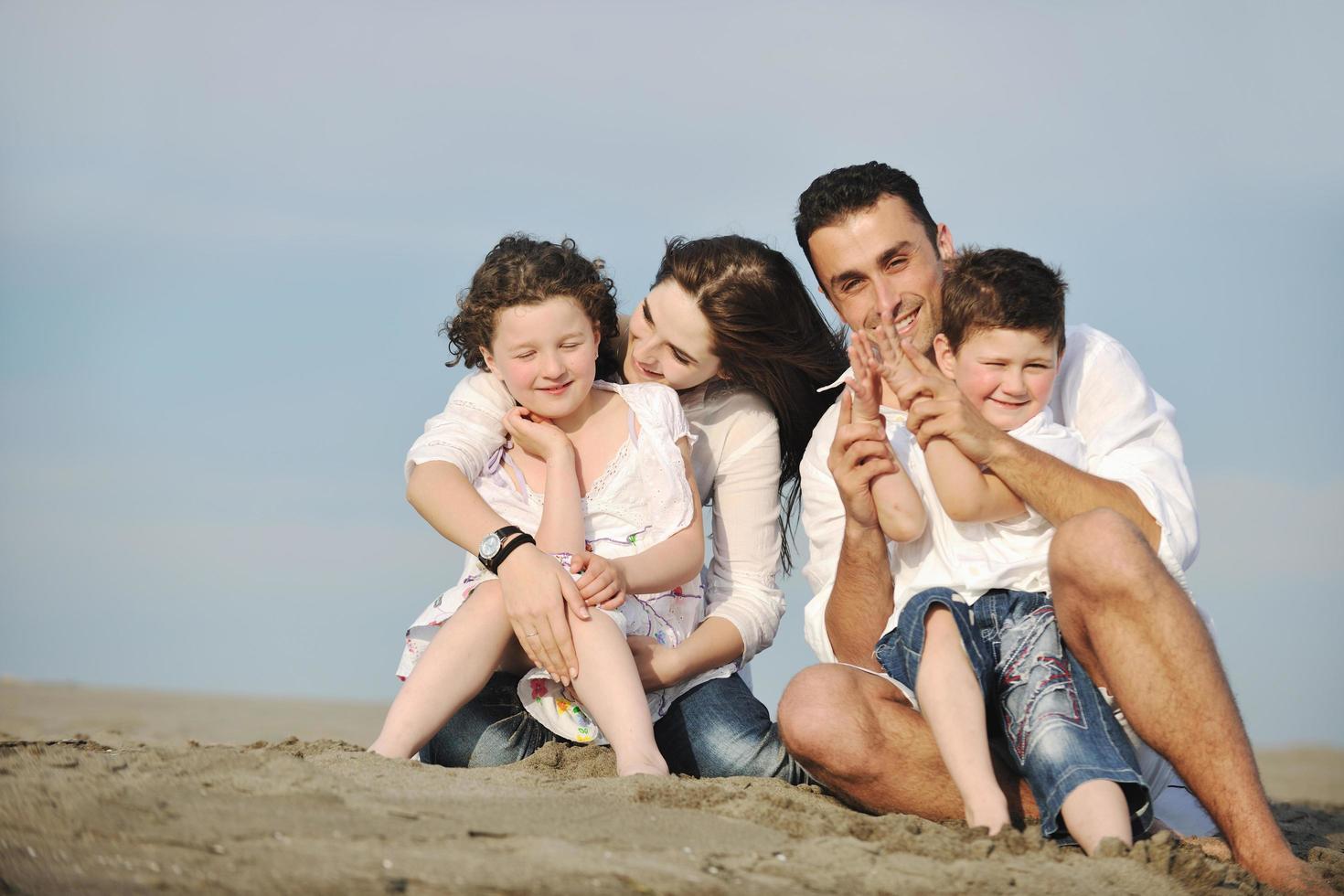 happy young family have fun on beach photo