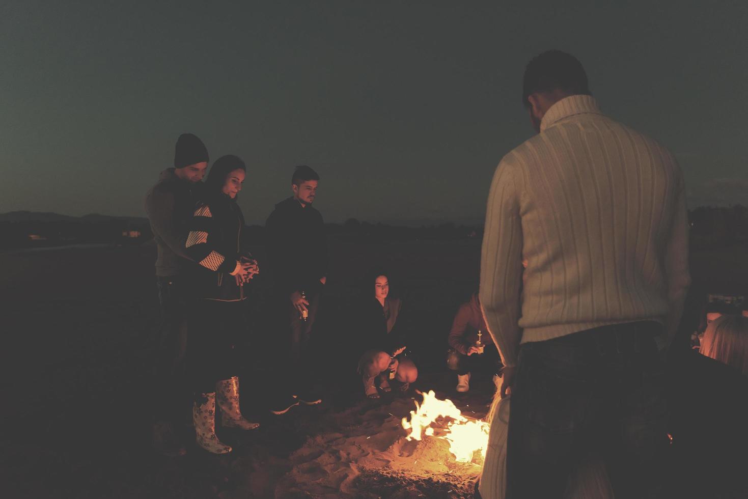 Friends having fun at beach on autumn day photo