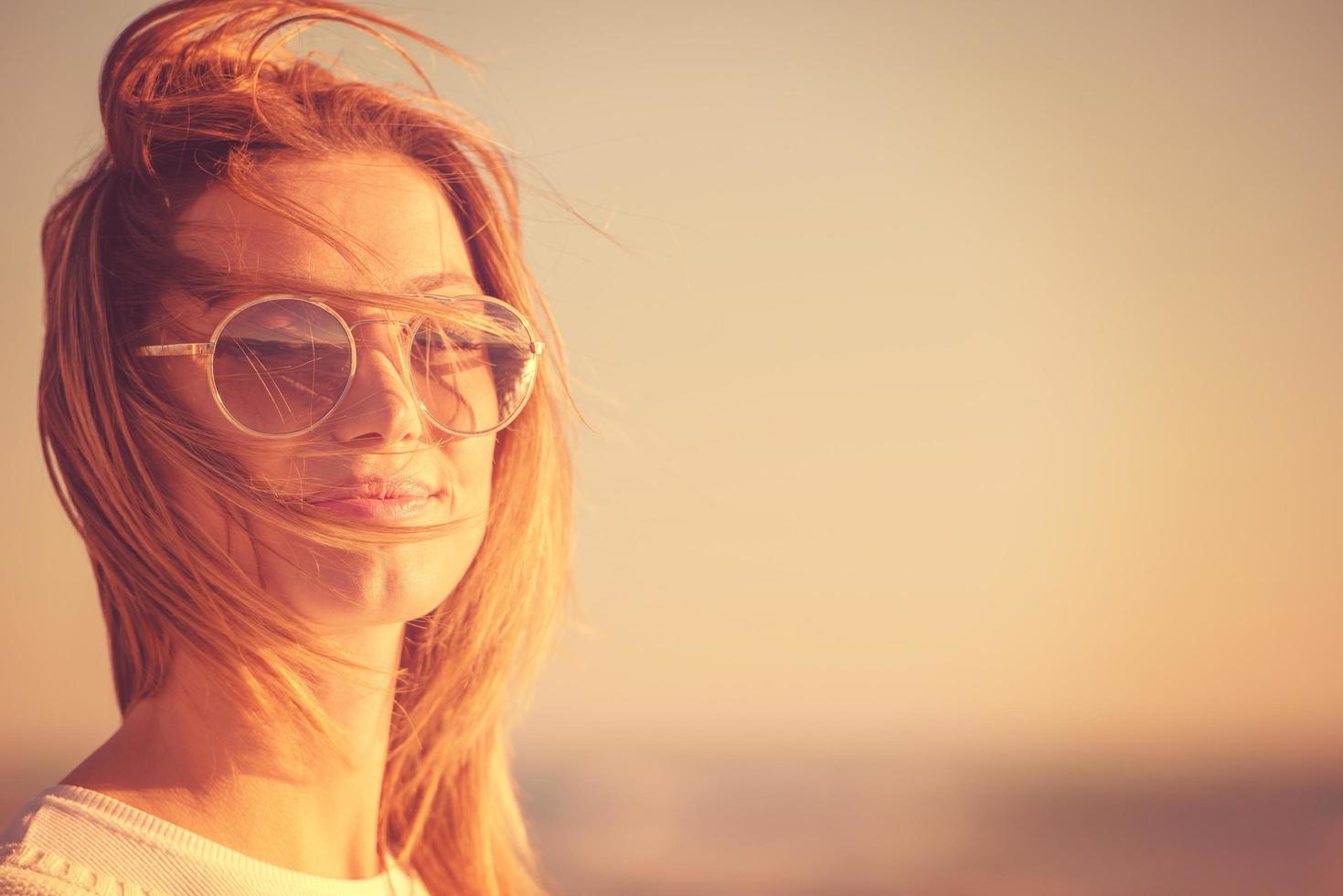 Young woman enjoying the warm autumn day photo