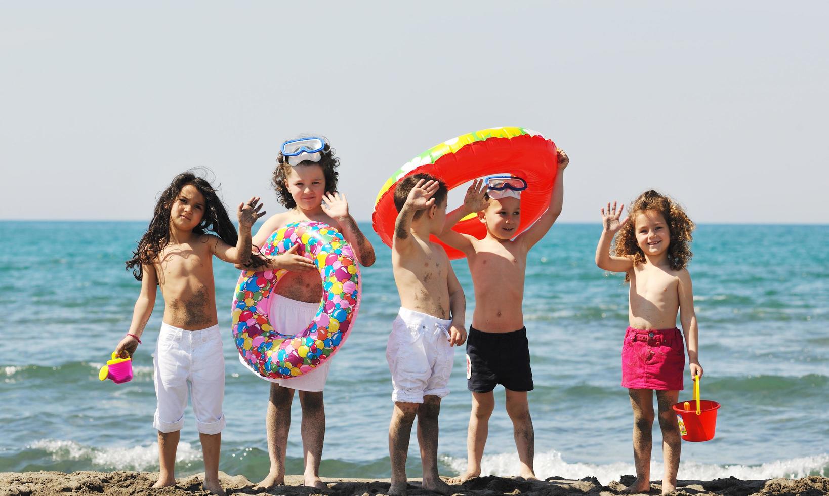 child group have fun and play with beach toys photo